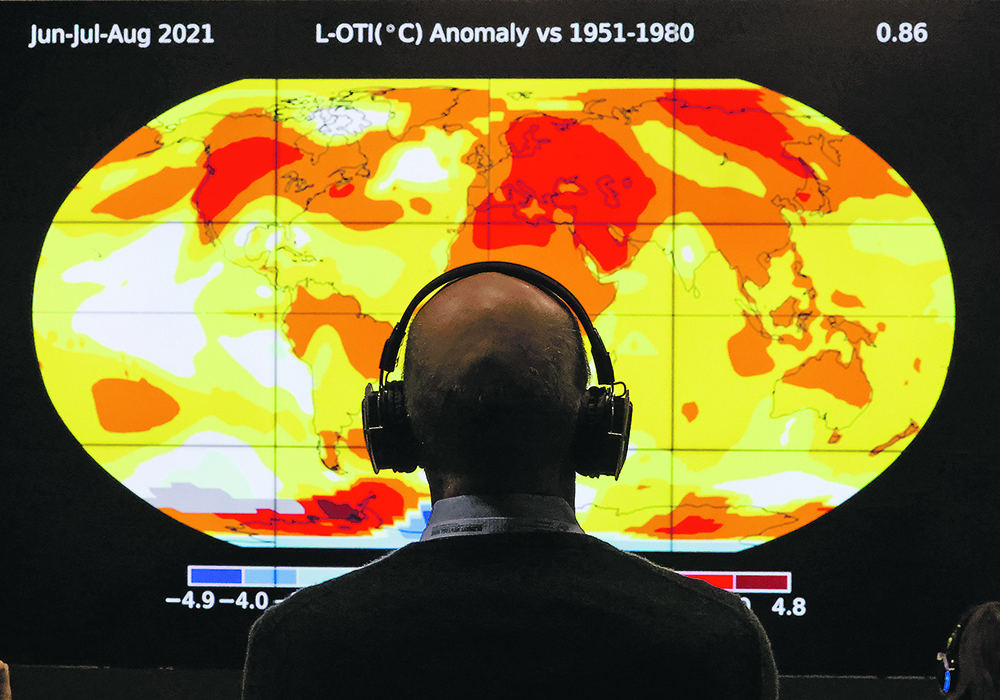 A delegate looks at a screen during the UN Climate Change Conference (COP26) in Glasgow, Scotland on Nov. 8, 2021. | Reuters Yves Herman photo