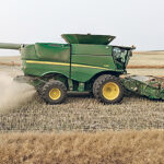 Josh Lade driving his John Deere S680 combine with the Seed Terminator installed near Osler, Sask. | Photo supplied by Josh Lade