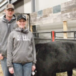 Myles and Colleen Hansen stand with the heifer calf that they consigned to the Maine-Anjou sale – which was donated back to them. | MELISSA BEZAN PHOTO