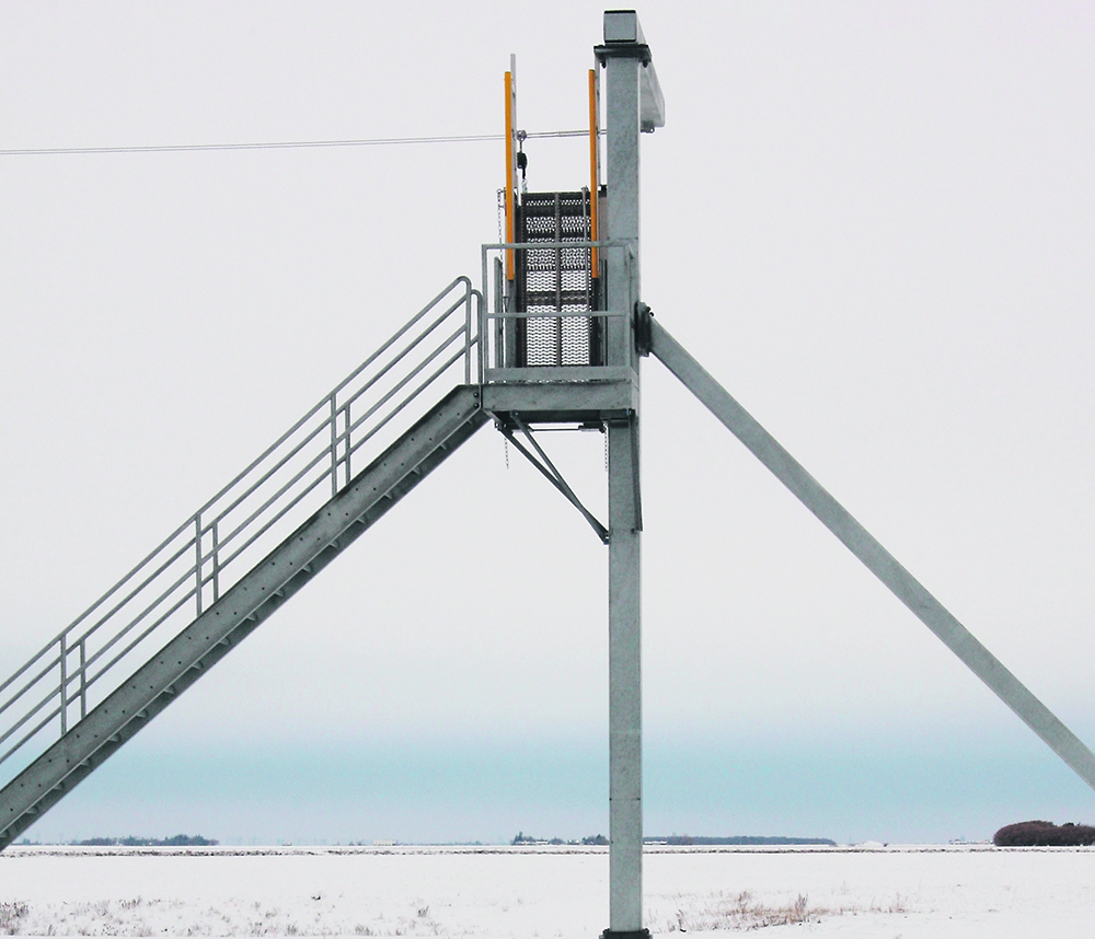 When climbing to the tops of rail cars, workers snap their safety harness to a cable that resembles a zip line. Worker safety was a number one priority  in the design. | Ron Lyseng photo