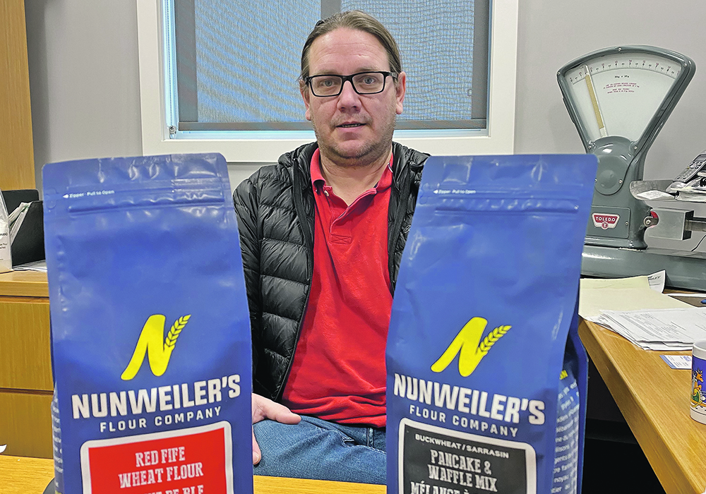 Russ Schroeder, owner of Marquis Milling & Grain, includes the name of the farmer who produced the organic grain that goes into each bag of Nunweiler’s Flour. | Brian Cross photo