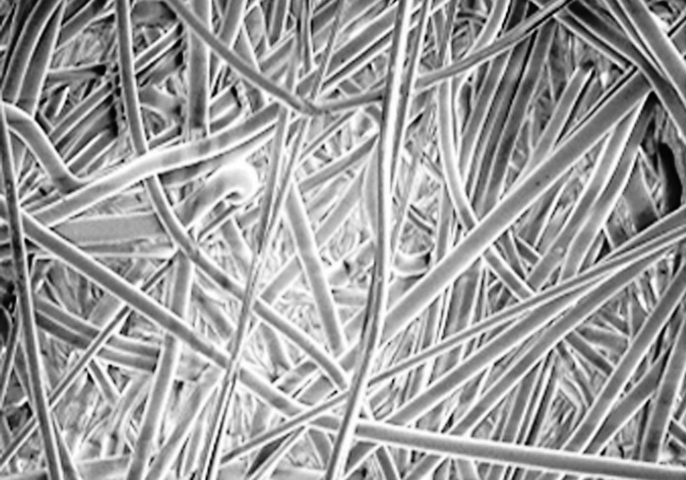 The straight, round synthetic MicroLoc fibers allow oil to flow faster and filter finer particles. This lowers restriction and reduces engine wear.  |  New Holland photo