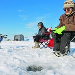 Cathy Mowat, Sue Schurman and Natalie Axten settle in for an afternoon of ice fishing at Gull Lake. | Mary MacArthur photo