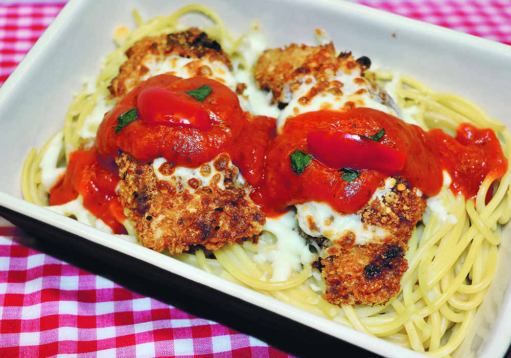 This baked parmesan chicken dish can be kept crisp when serving by not putting sauce under the chicken. Spoon only a little on top of the cheese.  |  Betty Ann Deobald photo