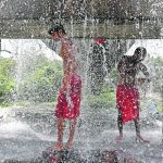 People cool off with water leaking from a broken pipe valve during hot weather in Kolkata, India, last month. The country’s pre-harvest crops are stressed by the record-breaking April heat wave, which has sent temperatures over 45 C and could reduce hopes for a record wheat crop of 110 million tonnes. | Reuters/Rupak De Chowdhuri photo