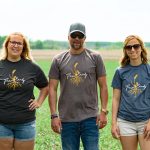 Farm Candy products include bunnyhugs, T-shirts, hats and sweatpants, and feature a wheat stalk and its root system to portray the foundation of so much of Saskatchewan. | Screencap via farmcandy.ca