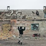 Workers repair the roof of a farm building that was damaged by a mortar during Russia’s attack on Ukraine. The U.S. Department of Agriculture believes there will be a 30 percent destruction/abandonment rate for wheat production in conflict zones, largely because of mined fields, unworkable craters created by bombs, debris in fields and lack of fuel or manpower. | Reuters/Alkis Konstantinidis photo