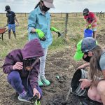 Students plant trees, shrubs, grasses and flowers through their One School One Farm projects. | Elizabeth Bekolay photo