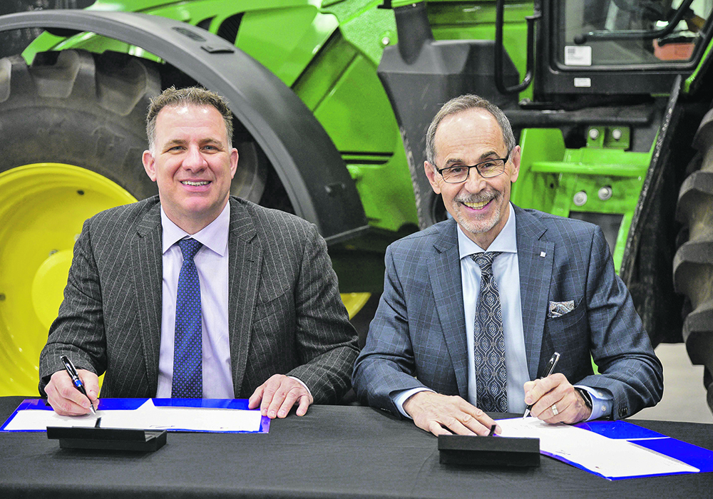 Stuart Cullum, Olds College President (left) and Larry Rosia, Sask Polytech president and CEO sign a MOU at Saskatchewan Polytechnic Saskatoon campus May 30. The two schools have agreed to collaborate in joint activities on the Olds College Saskatchewan Smart Farm.  |  William DeKay photo