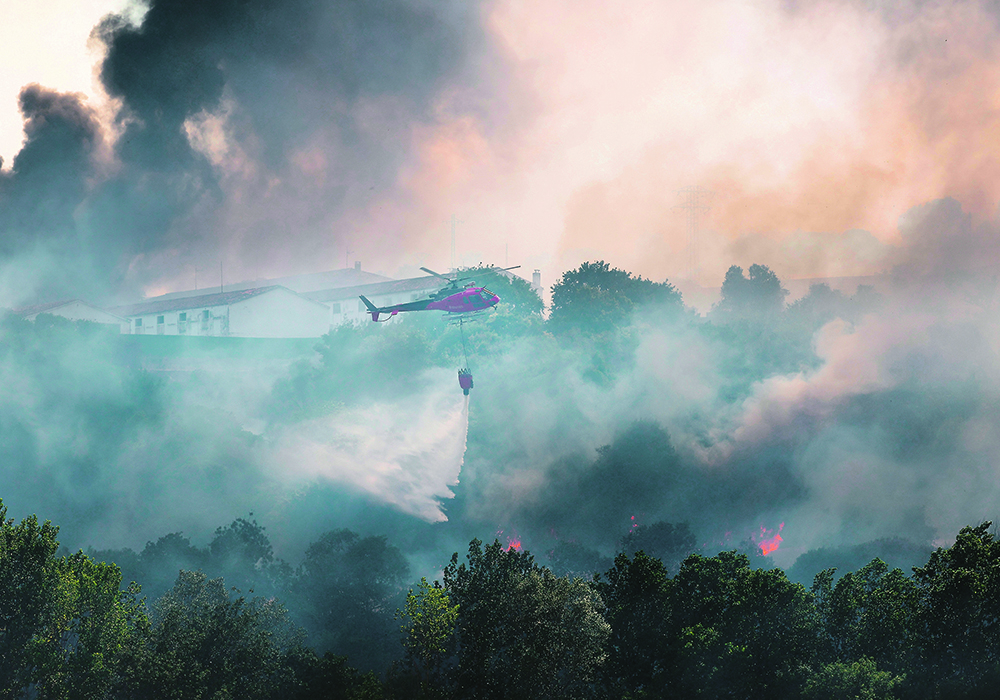 Heat and drought are crisping up a big swath of Europe this summer, damaging crops and causing fires, like this one last weekend on the edge of a hog farm near Belascoain, Navarre, Spain.  |  Reuters/Vincent West photo
