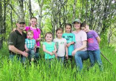 The Cayer family at 7Cs Farms near Balgonie, Sask: Andre, baby Andre, Anika, Sophia, Veronica, Katriona, Lauren and Lochlan.  |  Karen Briere photo