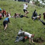 Every year in Gloucester, England, a group of folks with very little fear reflex gather at the top of a steep hill that’s said to have a gradient of 50 percent. Someone tosses out a wheel of double Gloucester cheese and within seconds of its rolling start, the mob begins its race to the bottom. | Screencap via npr.org/Adrian Dennis/AFP/Getty Images