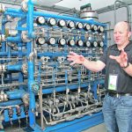 Cory Marquart, who works at the West Central Research and Outreach Center in Morris, MN, explains how the pilot plant at the centre combines nitrogen and hydrogen to make ammonia. | Robert Arnason photo
