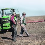 Ukrainian farmers wear body armour to plow fields near the front lines in April. Many producers in Ukraine have lost their homes, barns, tractors, fertilizer and other crop inputs because of the Russian invasion of their country. | Reuters/ Ueslei Marcelino photo