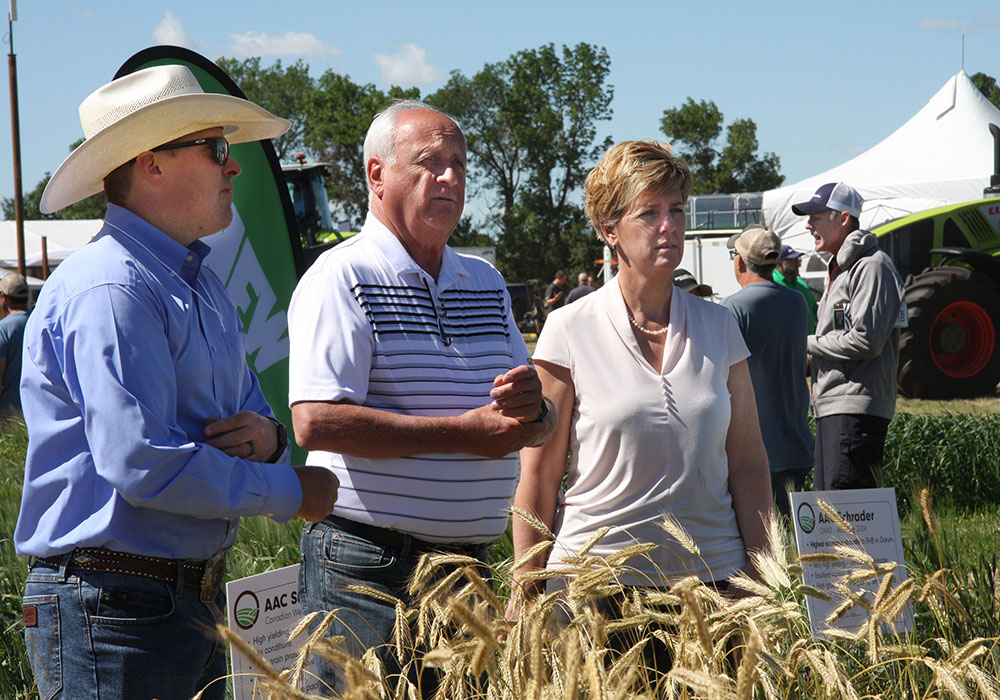 Alberta agriculture minister Nate Horner, Saskatchewan agriculture minister David Marit and federal agriculture minister Marie-Claude Bibeau at a crop plot at the Ag in Motion farm show. | KAREN BRIERE PHOTO