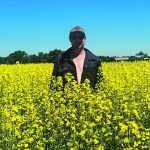 Dale Winter’s canola crop was looking good July 13 when he posed for a photo on his birthday on his farm near Ponoka, Alta. | Photo supplied by Dale Winters