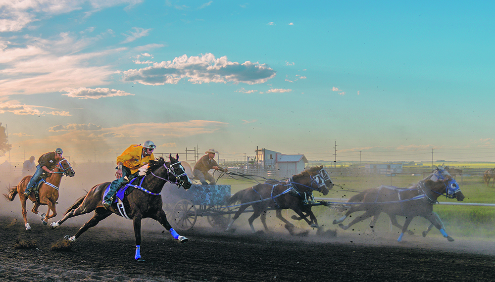Riders and a wagon race down the track. | Mike Sturk photo