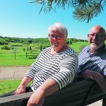 Janet and Warren Moseson sit on a bench near their Camrose, Alta., home. They say living in town means they can visit with friends, go for walks or enjoy the scenery. | Mary MacArthur photo