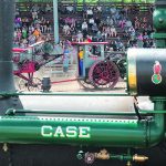 An old threshing machine is pulled in front of the grandstand for the afternoon steam vs. gas engine threshing competition. | Sandly Black photo
