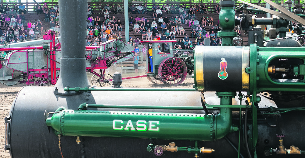 An old threshing machine is pulled in front of the grandstand for the afternoon steam vs. gas engine threshing competition. | Sandly Black photo