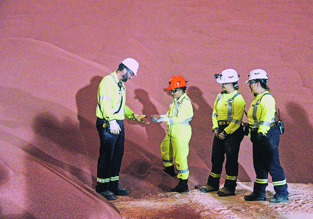 Deputy Prime Minister Chrystia Freeland examines a handful of granular potash during her tour of the Mosaic potash and phosphate mine east of Colonsay, Sask., Aug. 24.  |  William DeKay photo