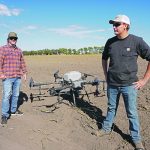 Maverick chief executive officer Adam Shaw, left, and pumpkin farmer Bear Bouwman discuss Bouwman’s move to the larger T40 application drone. | Maverick photo