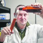Chris Eskiw, an associate professor in the University of Saskatchewan’s Department of Food and Bioproduct Science, pours beer into a graduated cylinder as part of his research into yeast and beer flavours. | William DeKay photo