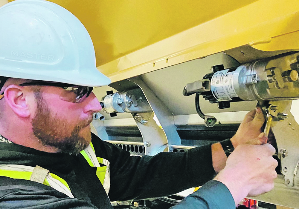 SeedMaster service manager Murray Soanes installs the electric metering motors that provide singulated seed selection. Company CEO Don Henry worked evenings and weekends to help assemble drills.  |  Photo supplied by SeedMaster
