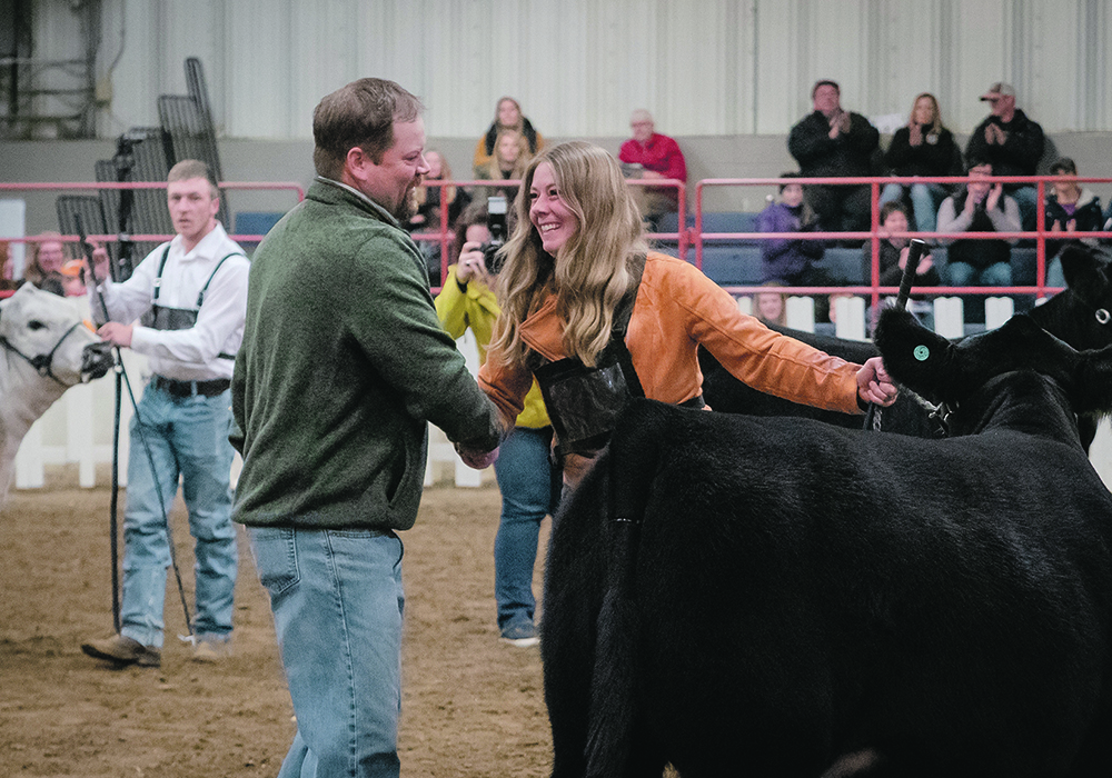Chad Wilson of Wawota, Sask., one of three judges in the Little Lady Classic, shakes hands with Laura Horner of the Horner Cattle Co. near Minnedosa, Man., after her female was declared the champion in the all-breed class. There were 50 entries in the class. | Sandy Black photo