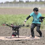 Seungbum Steve Ryu, research technician with University of Saskatchewan researcher Steve Shirtliffe, prepares a drone for launch. It is a DJI M600 with a Micasence 5 band multispectral and 100 MP RGB sensors. | D. Stobbe photo