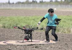Seungbum Steve Ryu, research technician with University of Saskatchewan researcher Steve Shirtliffe, prepares a drone for launch. It is a DJI M600 with a  Micasence 5 band multispectral and 100 MP RGB sensors.  |  D. Stobbe photo