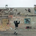 Workers repair the roof of a farm building that was damaged by a mortar in the village of Malaya Rohan in Ukraine’s Kharkiv region April 9. | Reuters/Alkis Konstantinidis photo