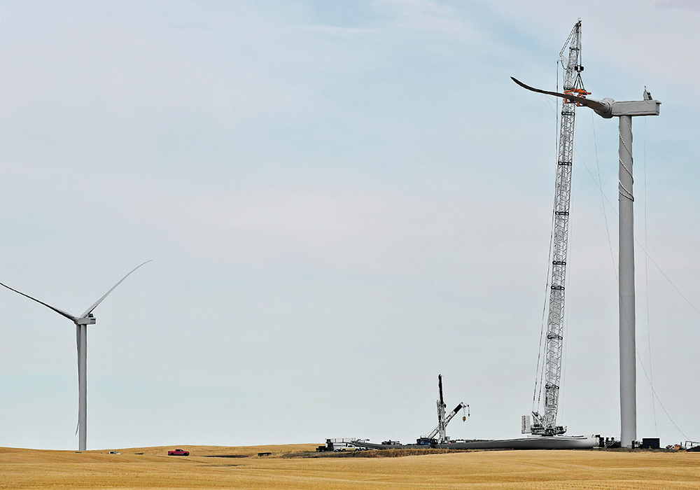 Workers piece together one of the turbines. | Kevin Link photo