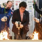 From left Darcy McKay, STARS flight paramedic, Kim Hextall, president of Canadian Western Agribition and Andrea Robertson, CEO of STARS Air Ambulance burn the brand at this year's event. | William DeKay photo