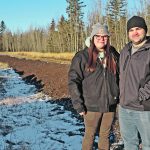 James Yuha and his fiancé, Kim St. Germaine, stand in front of the compost pile at their Silver Valley, Alta., farm. | Mary MacArthur photo