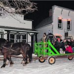 Cornie Friesen of Austin, Man., drives his team of Clydesdales through the Pioneer village Dec. 10. With two hay wagons and two teams of horses, visitors can take a ride or just walk the decorated trail. | Sandy Black photo