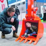 Four-year-old Kyle Krapp and his father, Chris Krapp, check out the bucket of a Kubota back hoe. | Sandy Black photo