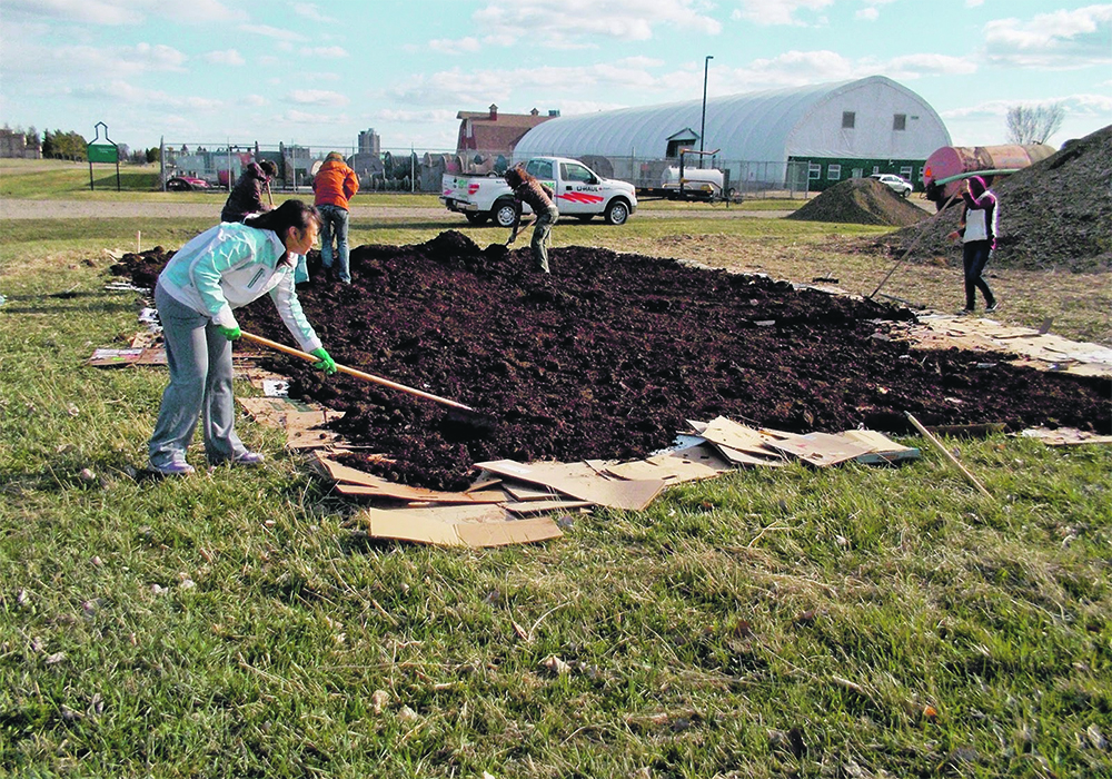 Volunteers at the Prairie Urban Farm on the University of Alberta’s South Campus get started on a new plot. | Debra Davidson photo