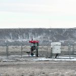 An active natural gas well operates near the South Saskatchewan River in southern Alberta. Inactive wells in need of clean-up have become a major issue in the province in recent years. | Alex McCuaig photo