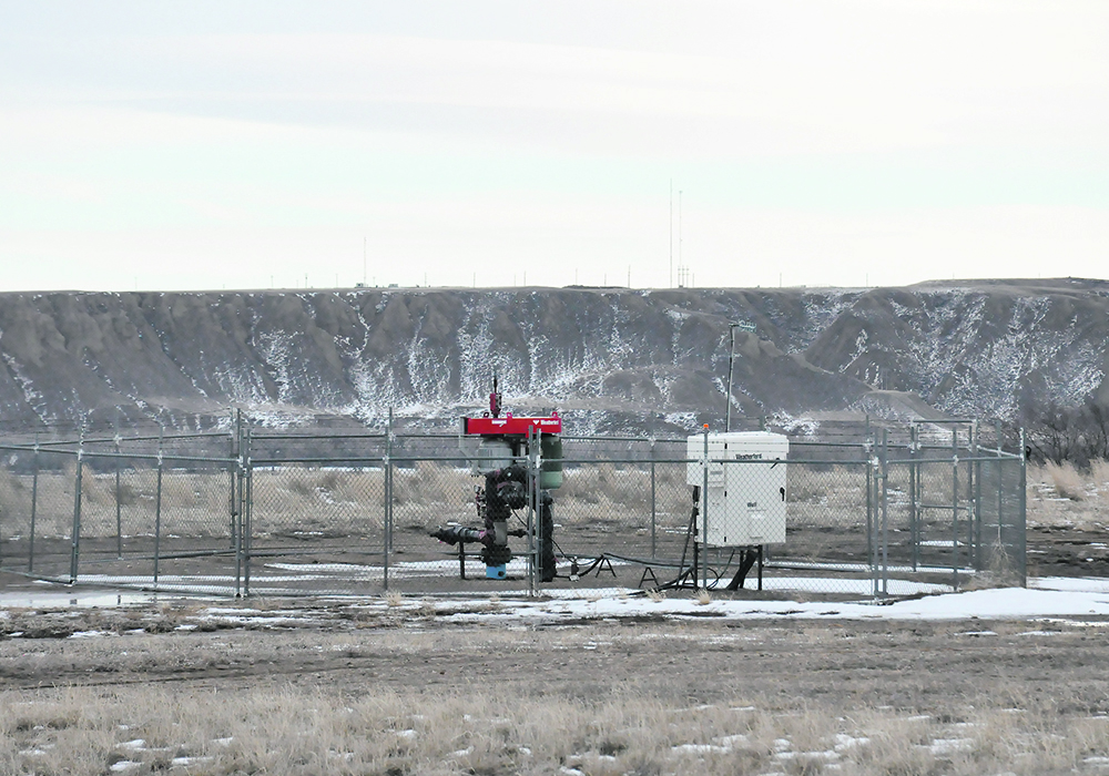 An active natural gas well operates near the South Saskatchewan River in southern Alberta. Inactive wells in need of clean-up have become a major issue in the province in recent years.  | Alex McCuaig photo