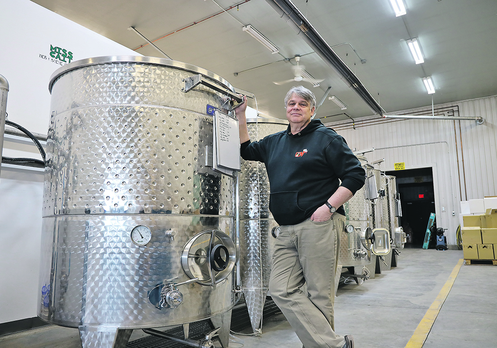 Will Munsey stands beside his specially designed mead vessels in the old fire station in New Sarepta, Alta.  |  Mary MacArthur photo