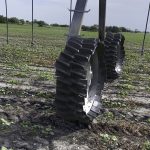 The Swift wheel features a unique sinusoidal tread design that generates a helical, DNA-shaped travel path between the two out-of-phase wheels on the irrigation tower. The trailing wheel fills in the ruts created by the leading wheel. | Shark Wheels photo