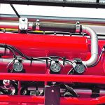 Close-up of a sprayer boom showing the U-shaped, recirculating, plumbing.