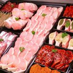Grocery store meat display featuring various pork cuts.