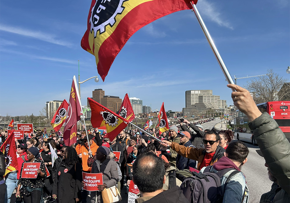 Striking members of the Public Service Alliance of Canada from Ontario and Quebec meet on the Portage Bridge in Ottawa.
