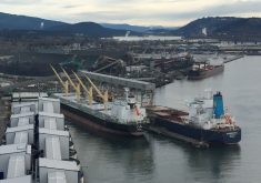 Aerial photo of the Port of Vancouver, with a bulk grain ship at dock waiting to be loaded.