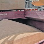 Wheat sits in the hold of a bulk crop carrying ship.