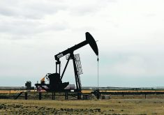 An oil well pumpjack at work in a field in Alberta.
