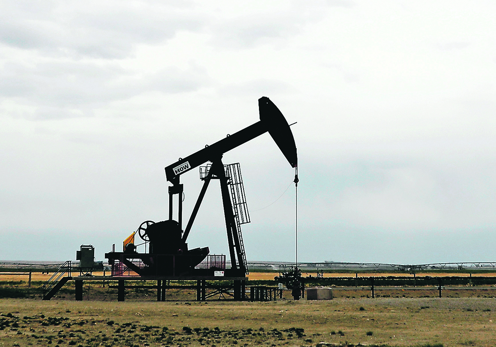 An oil well pumpjack at work in a field in Alberta.