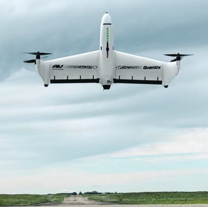 A drone capable of taking off vertically hovers a few feet above the ground.